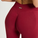 Legging Admyre Moonlight rojo de cintura alta con efecto moldeador y tejido técnico elástico para entrenamiento.